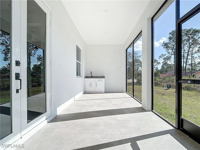 unfurnished sunroom featuring sink