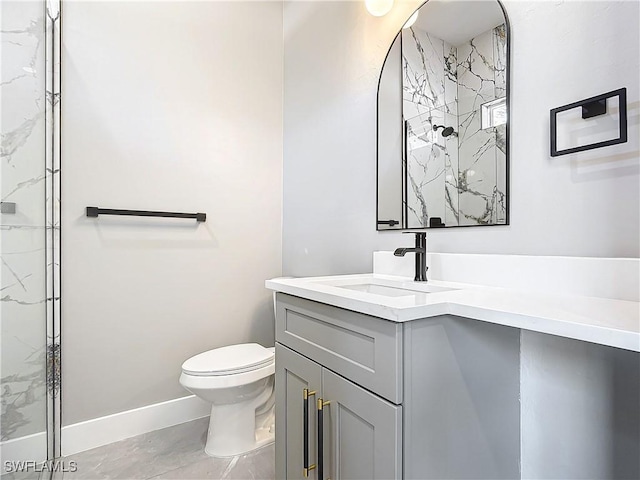 bathroom featuring a tile shower, vanity, and toilet