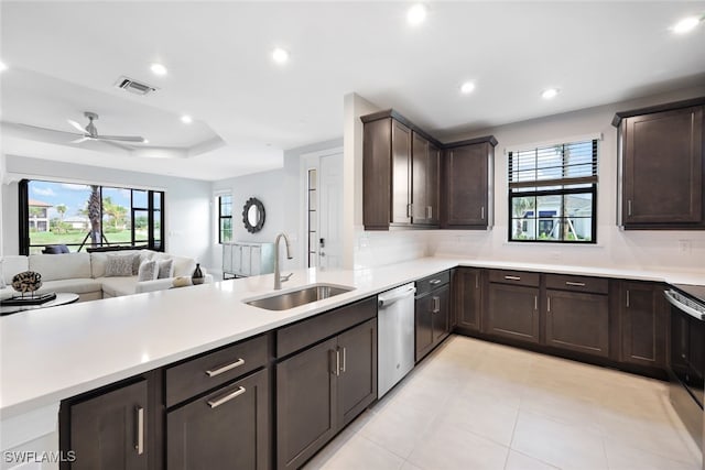 kitchen with appliances with stainless steel finishes, tasteful backsplash, dark brown cabinets, ceiling fan, and sink