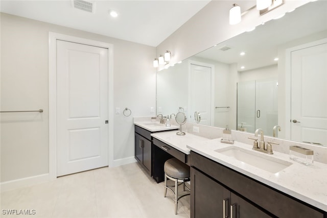 bathroom featuring tile patterned floors, vanity, and walk in shower