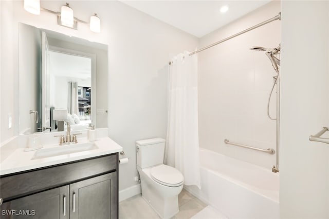 full bathroom with tile patterned flooring, shower / bath combo with shower curtain, vanity, and toilet