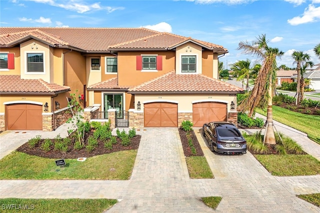 mediterranean / spanish house with a garage