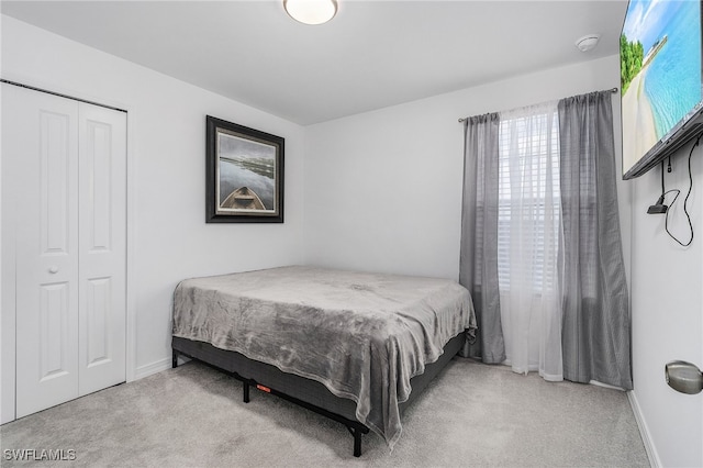 carpeted bedroom with a closet