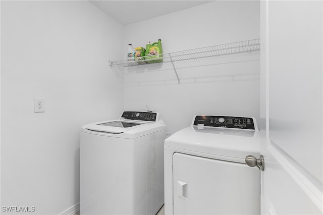 laundry room featuring washing machine and clothes dryer