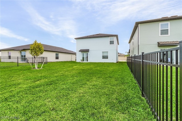 back of house with a yard