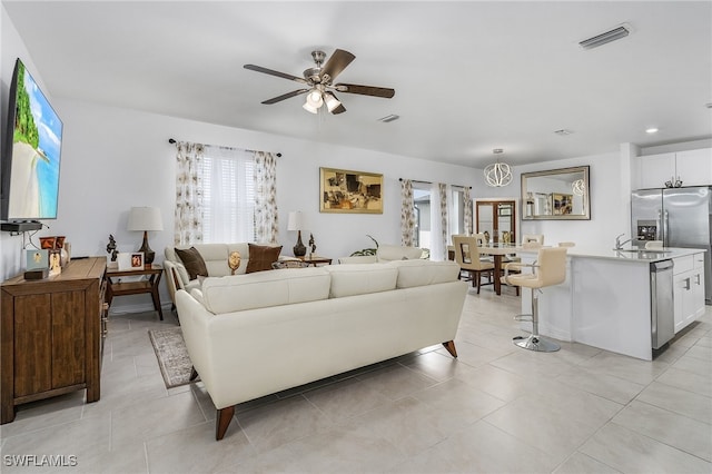 living room with ceiling fan and light tile patterned floors