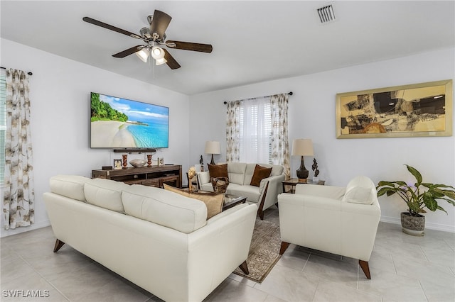 tiled living room with ceiling fan