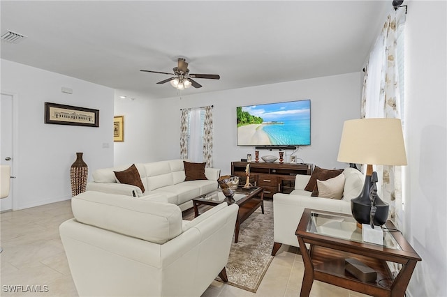 living room featuring light tile patterned floors and ceiling fan