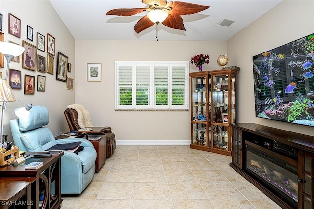 sitting room featuring ceiling fan