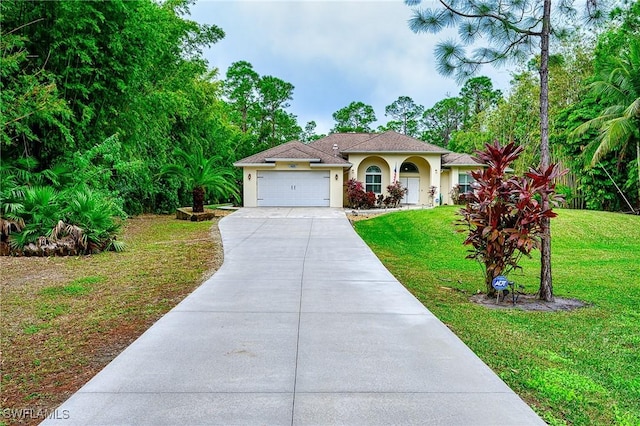 view of front of home featuring a garage and a front lawn