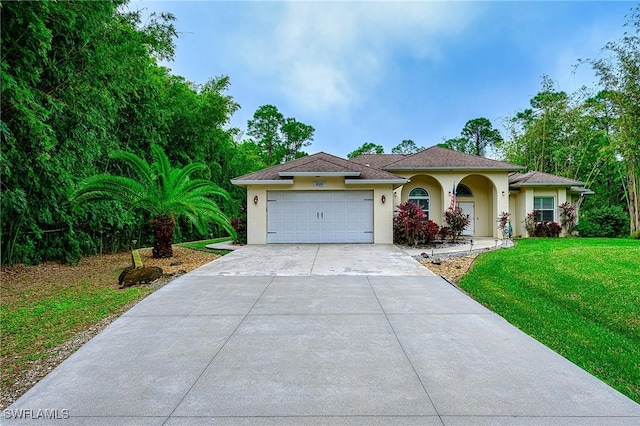 view of front of property featuring a front yard and a garage