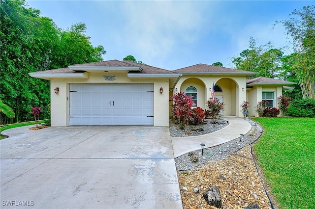 view of front of home with a garage and a front yard