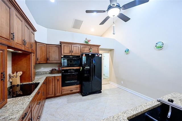 kitchen with light stone counters, ceiling fan, black appliances, light tile patterned floors, and high vaulted ceiling