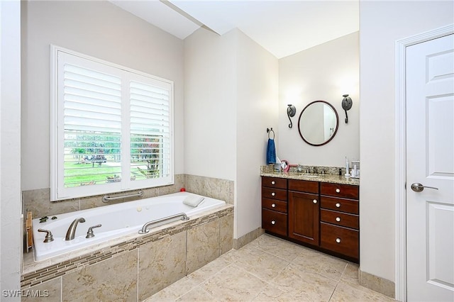 bathroom featuring vanity and a relaxing tiled tub