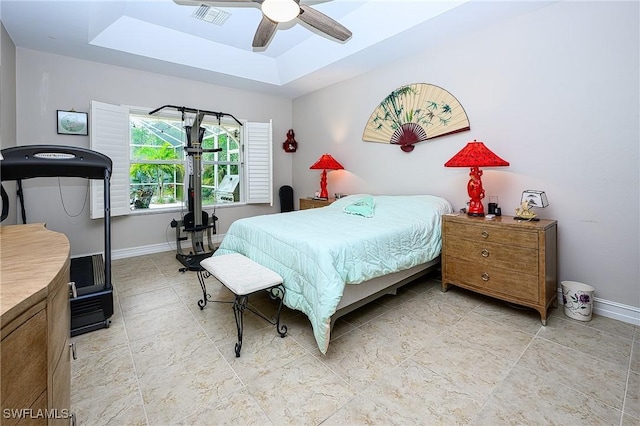 bedroom featuring a tray ceiling and ceiling fan