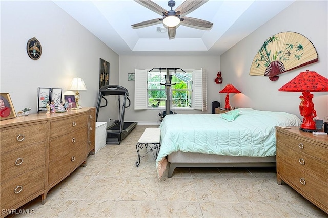 bedroom featuring a tray ceiling and ceiling fan