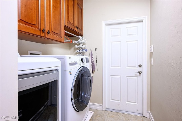 laundry room with cabinets and washing machine and dryer