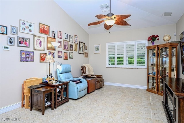 living area with ceiling fan and lofted ceiling