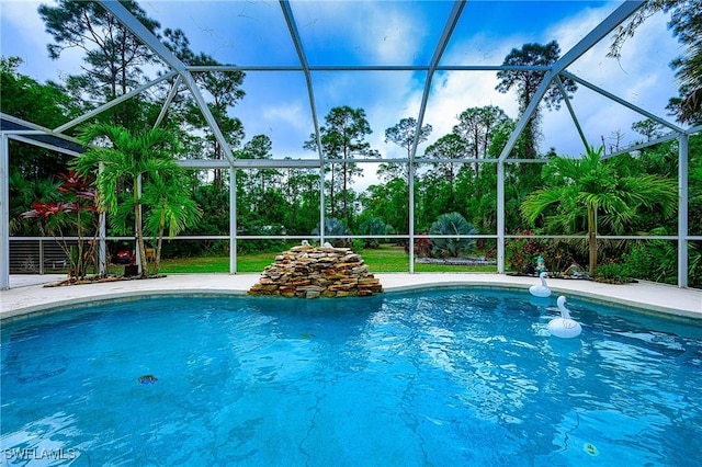 view of swimming pool with glass enclosure