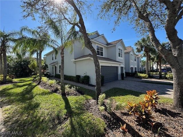 view of side of property with a lawn and a garage