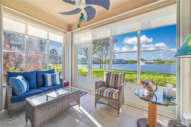 sunroom / solarium with ceiling fan, a water view, and a healthy amount of sunlight