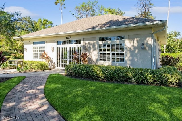 back of house with a lawn and french doors