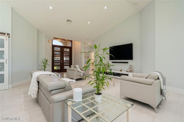 tiled living room with lofted ceiling and french doors