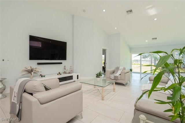 tiled living room with high vaulted ceiling