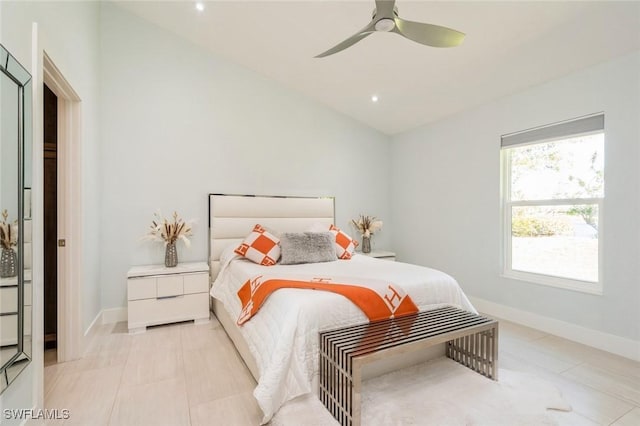 bedroom featuring ceiling fan, light tile patterned flooring, and lofted ceiling