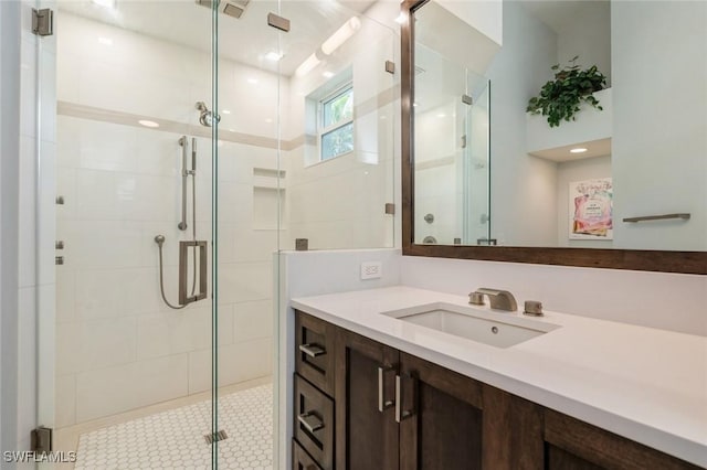 bathroom with vanity and a shower with shower door