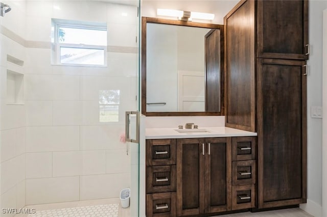 bathroom featuring vanity and a tile shower