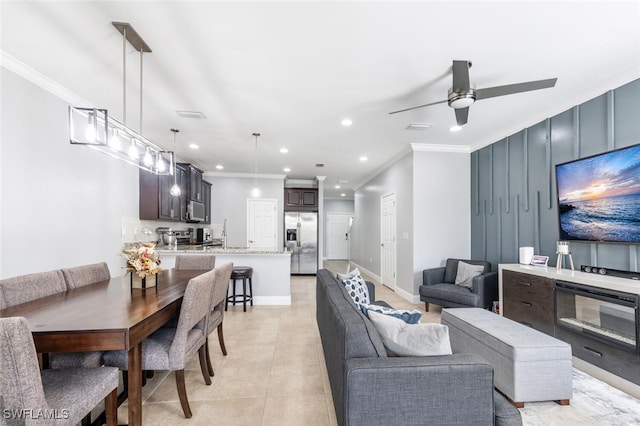 tiled living room with crown molding and ceiling fan