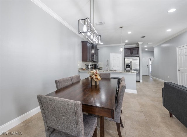 tiled dining space featuring crown molding