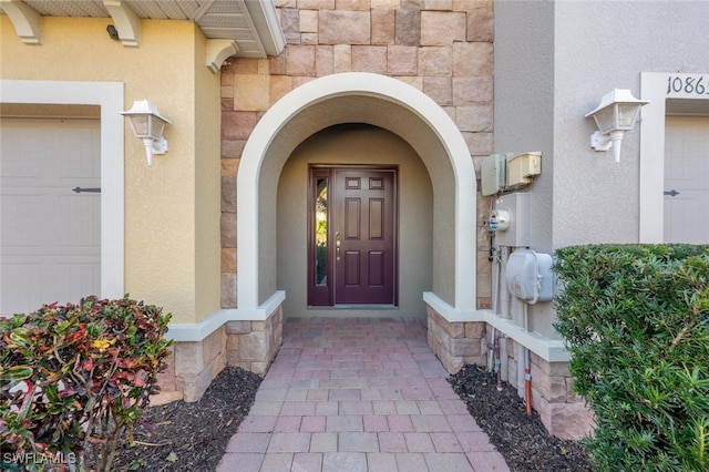 view of exterior entry with a garage