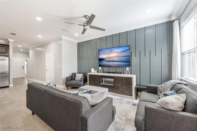 tiled living room featuring crown molding and ceiling fan