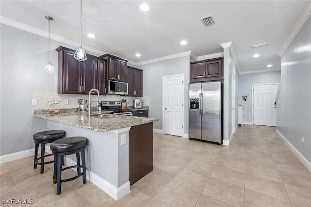 kitchen with pendant lighting, backsplash, stainless steel appliances, light stone counters, and kitchen peninsula