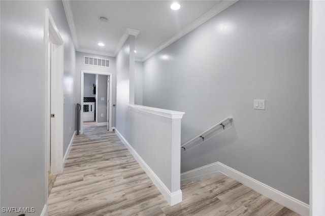 hall featuring crown molding and light hardwood / wood-style floors