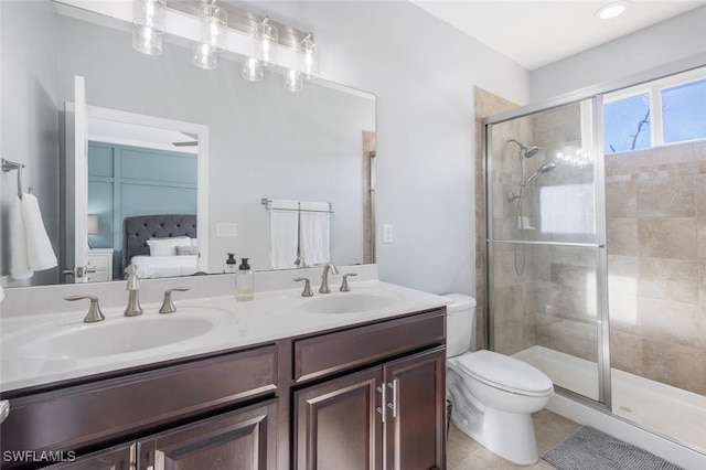 bathroom with an enclosed shower, vanity, tile patterned floors, and toilet