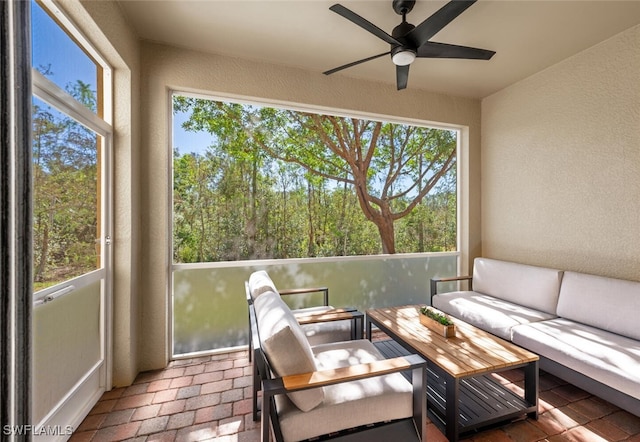 sunroom / solarium featuring ceiling fan