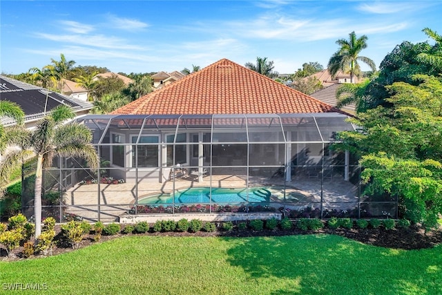 back of property featuring a patio, a lanai, and a lawn