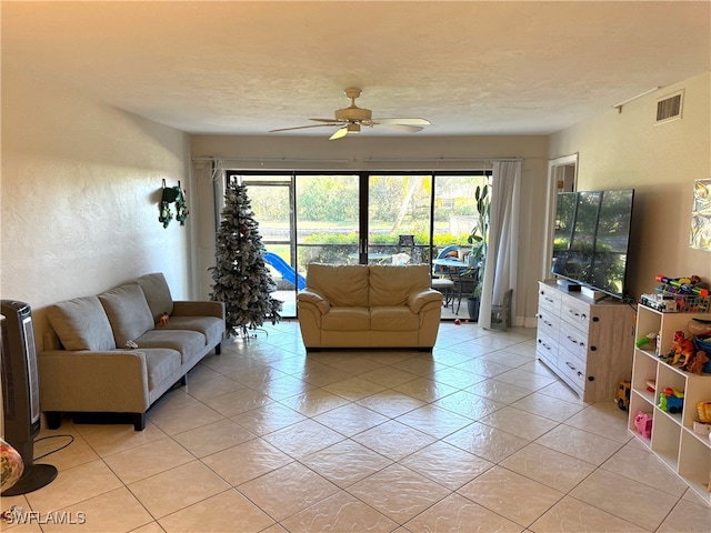 tiled living room with ceiling fan