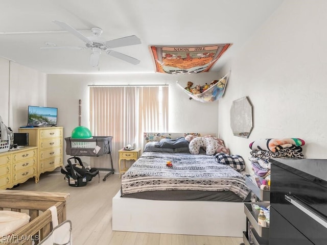 bedroom with light hardwood / wood-style floors and ceiling fan