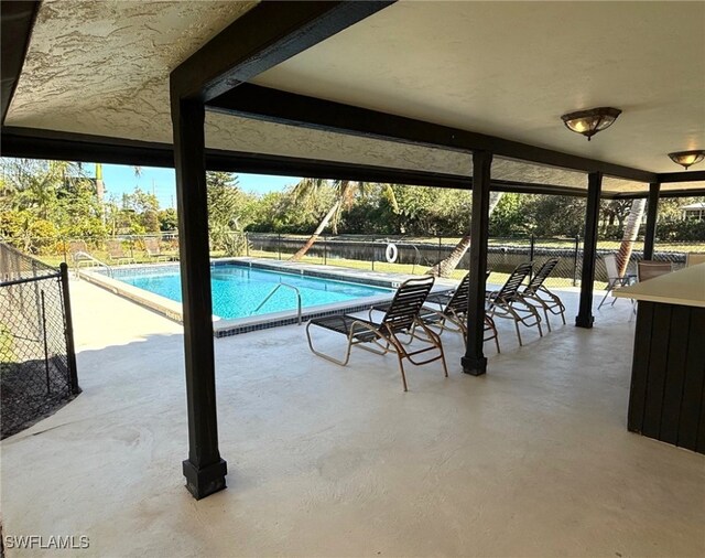 view of swimming pool featuring a patio area