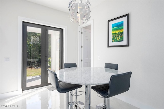 dining room featuring french doors and an inviting chandelier