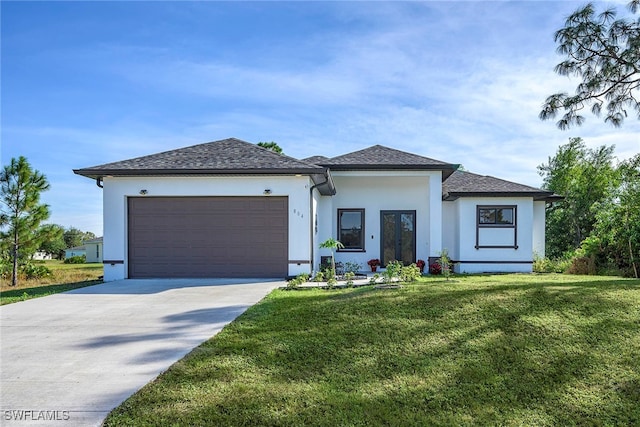 view of front of home with a front yard and a garage