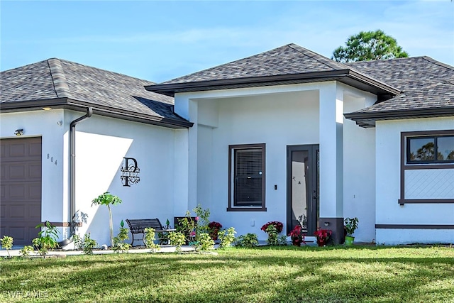 doorway to property featuring a yard and a garage