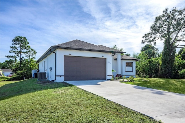 view of front facade with central AC, a front yard, and a garage