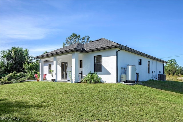 back of property with a yard and cooling unit