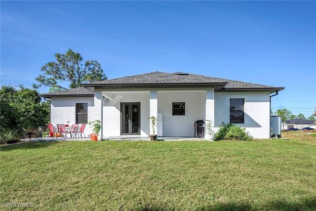 back of property featuring a yard and a patio