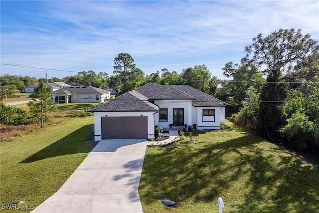 view of front of property with a garage and a front lawn